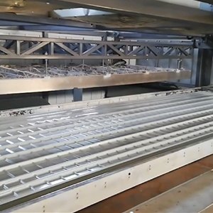 The vacuum forming machine is producing ABS trays.