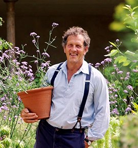 A man is hugging a potted flower.